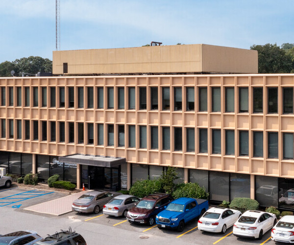 Outdoor of building with cars parked in the lot